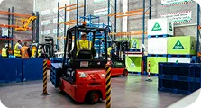 A_man_operates_a_forklift_inside_a_warehouse_ISM_Driving_lessons