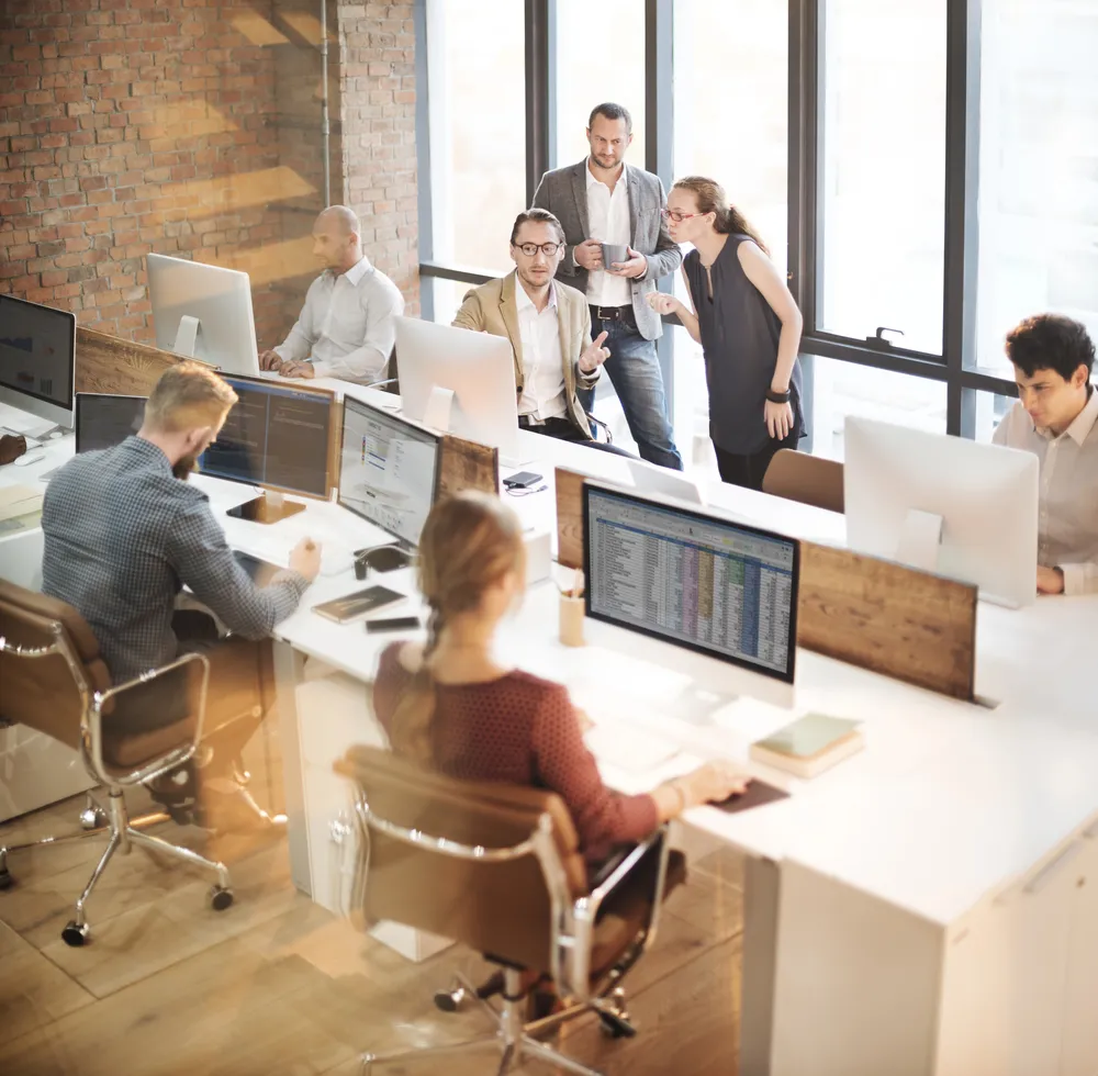 A_diverse_group_of_professionals_collaborating_in_a_modern_office _ISM Training_and_Recruitment