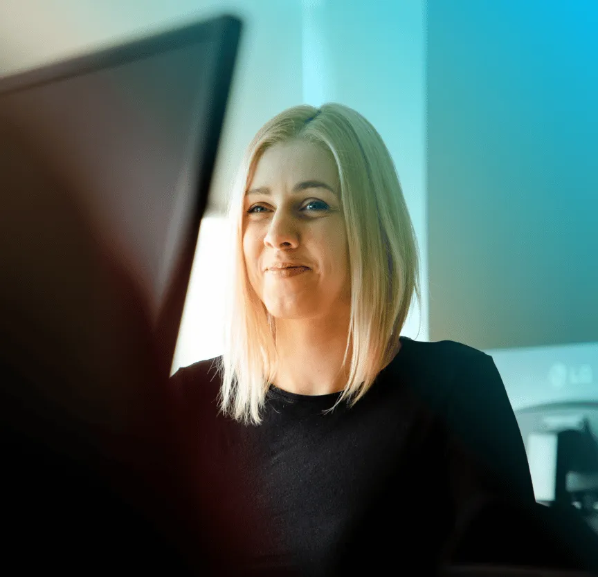 A_woman_sitting_at_a_computer _ISM Training_and_Recruitment
