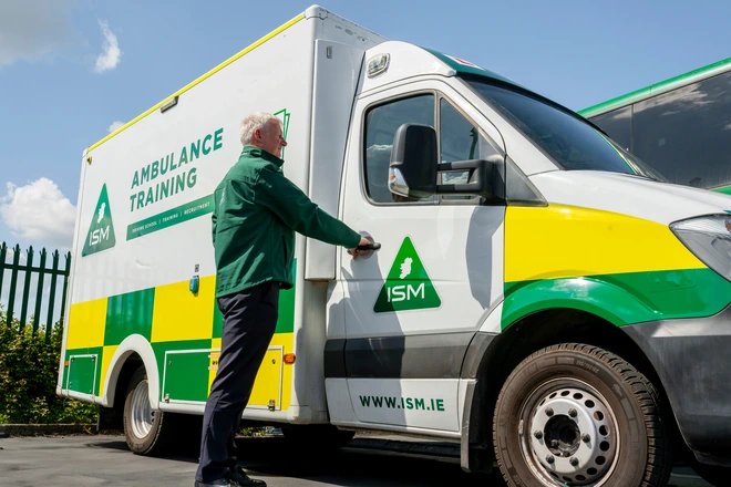 Instructor_is_standing_beside_ambulance_ISM Training_and_Recruitment