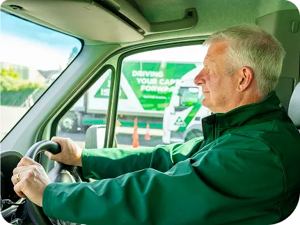A_man_focused_on_driving_a_truck_on_a_clear_road_ISM_Driving_lessons