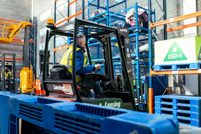 A_forklift_truck_in_a_warehouse_with_a_man_operating_it _ISM Training_and_Recruitment