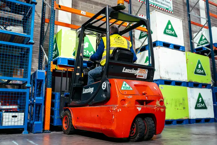 A_forklift_truck_in_a_warehouse_surrounded_by_stacked_boxes _ISM_Training_and_Recruitment