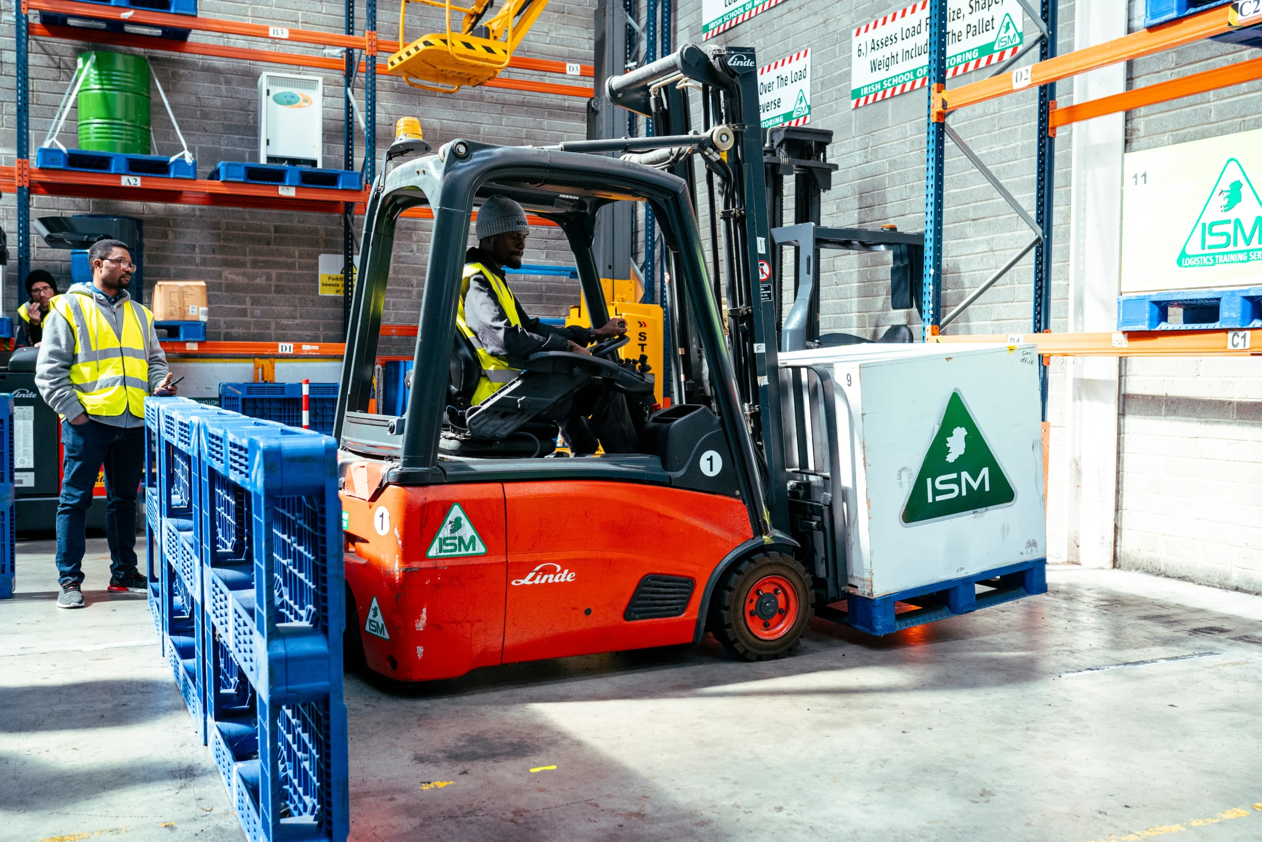 A_forklift_truck_in_a_warehouse_with_a_man_standing_at_the_back _ISM Training_and_Recruitment