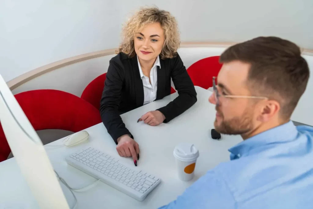 A_man_and_woman_seated_at_a_desk_focused_on_a_computer_screen _ISM Training_and_Recruitment