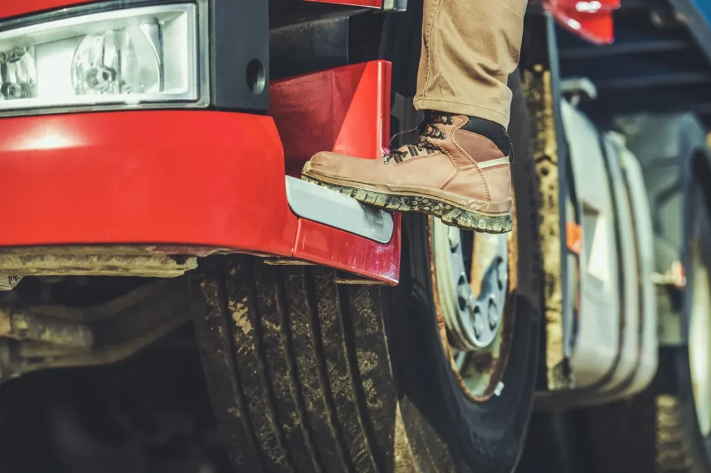 A_person_stands_confidently_at_the_front_of_a_truck _ISM Training_and_Recruitment