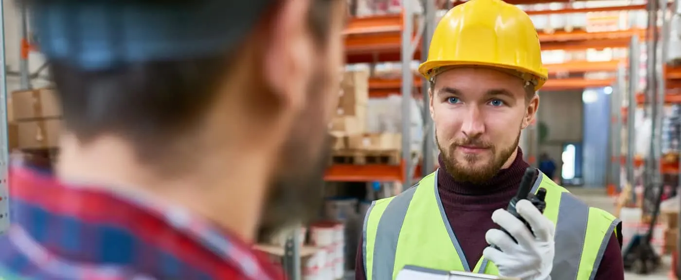A_man_wearing_a_hard_hat_is_speaking_on_a_cell_phone _ISM Training_and_Recruitment