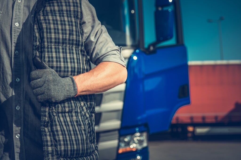 A_man_wearing_a_vest_and_gloves_stands_beside_a_truck _ISM_Training_and_Recruitment