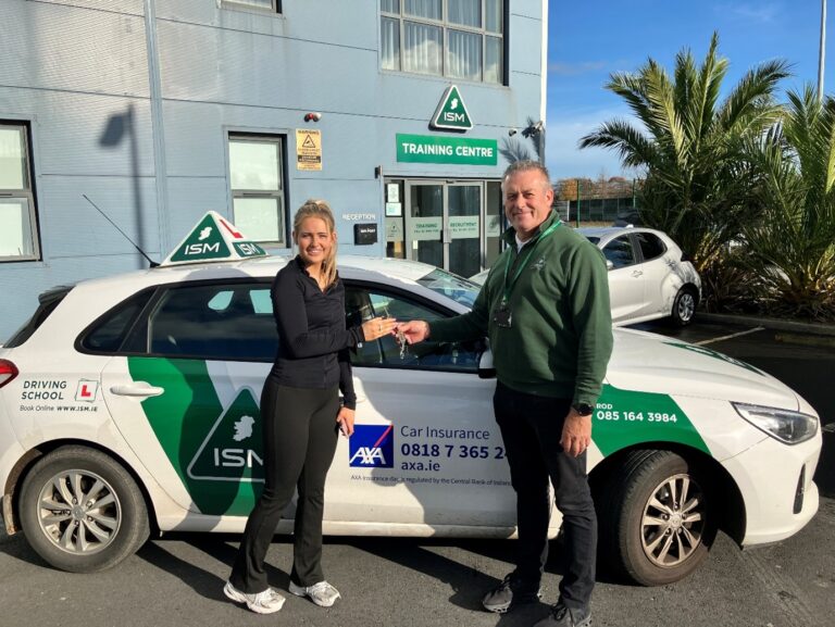 Young_lady_standing_with_driving_instructor_ISM_Driving_Lessons