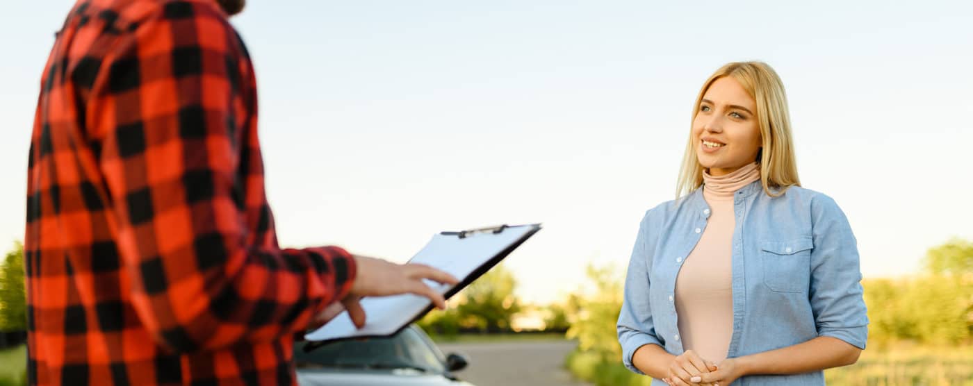 A_man_and_woman_stand_together_in_front_of_a_parked_car _ISM_Training_and_Recruitment