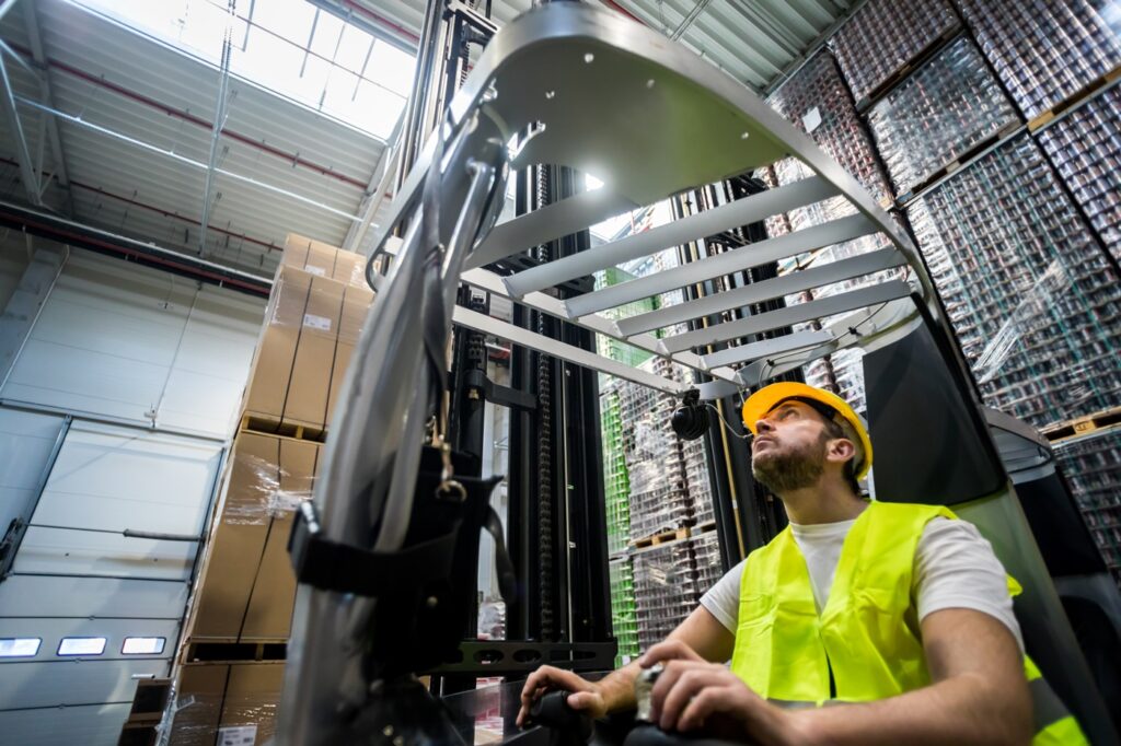 A_man_wearing_a_safety_vest_sits_on_a_forklift _ISM_Training_and_Recruitment
