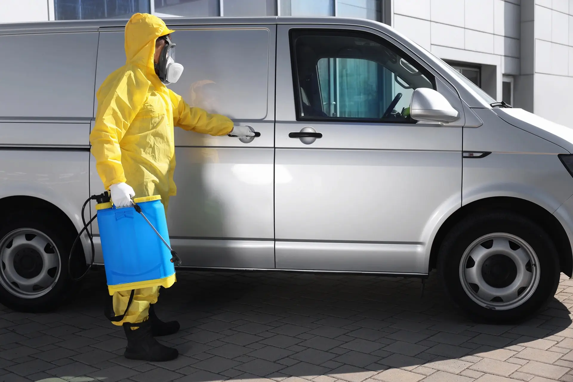 A_man_in_a_yellow_suit_and_safety_gear_stands_beside_a_van_ISM_Training_and_Recruitment