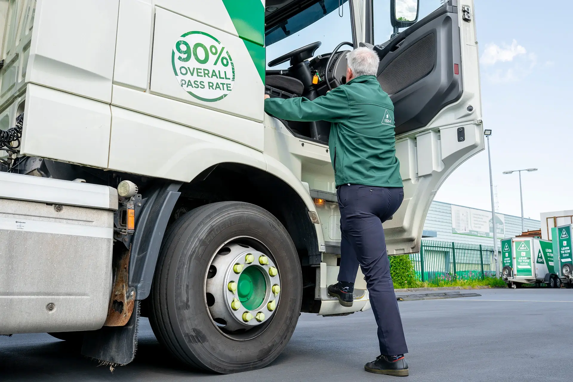 A_man_is_climbing_large_ISM_truck_ISM_Driving_Lessons