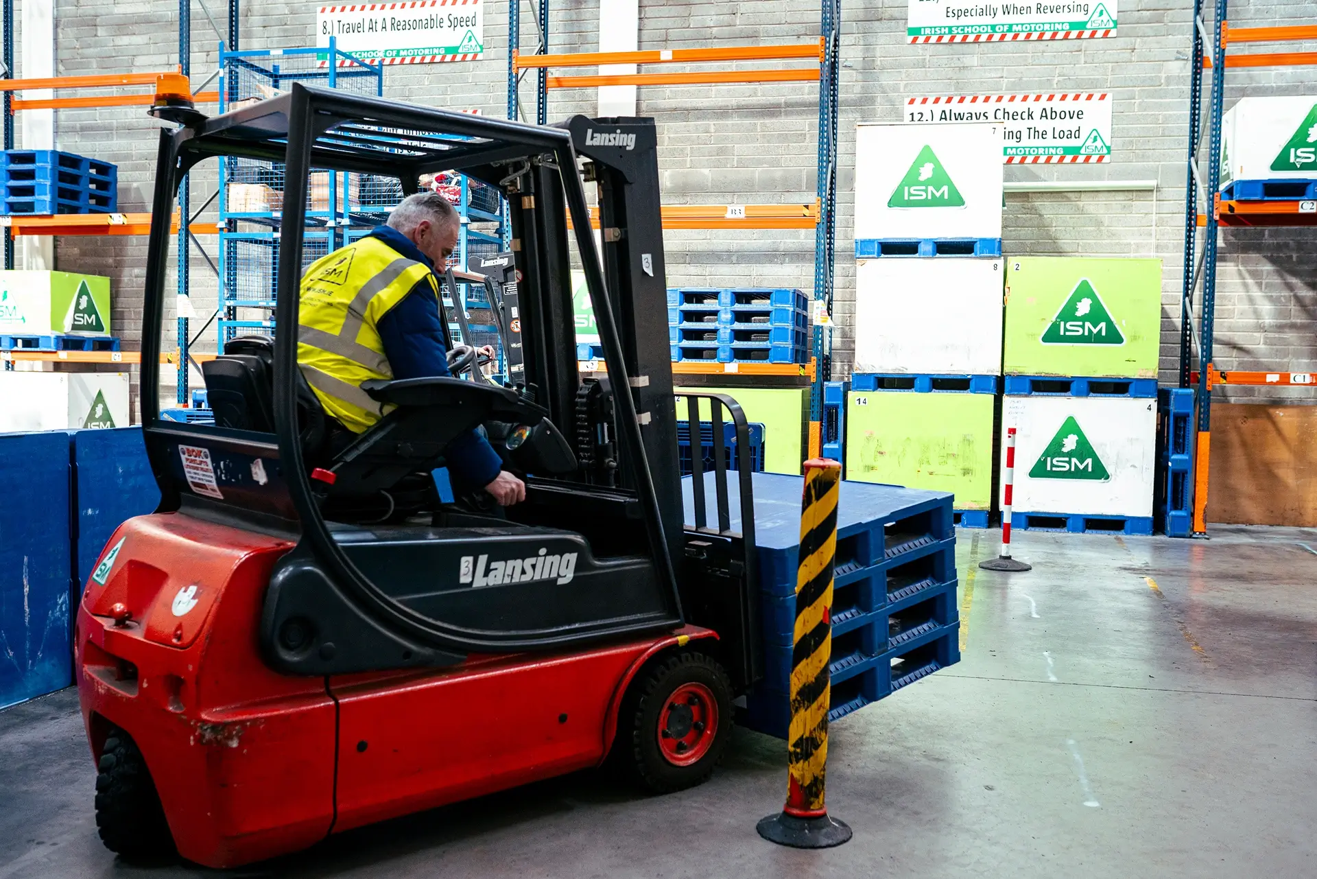 A_instructor_in_a_warehouse_driving_a_forklift ISM_Training_and_Recruitment