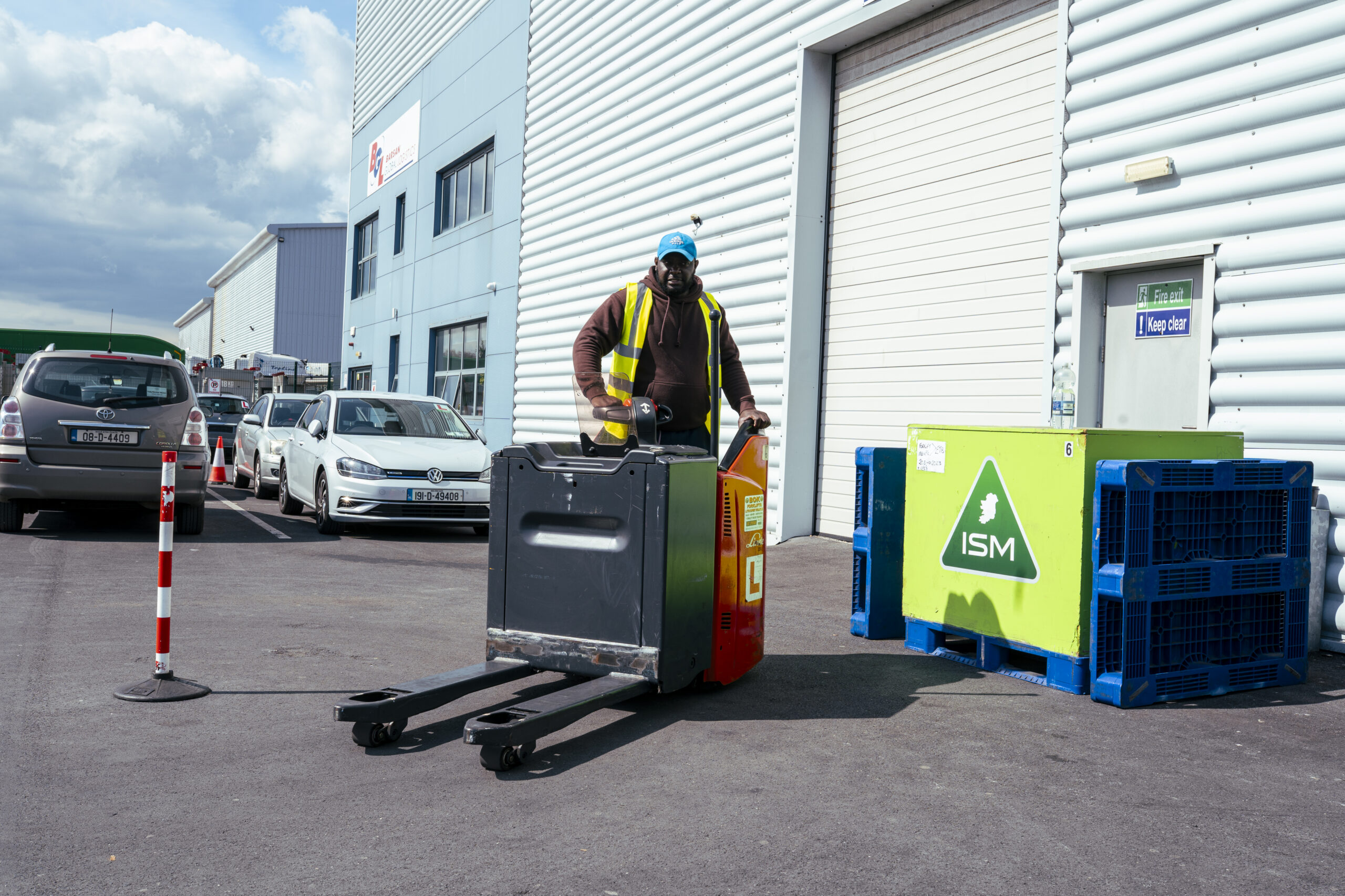 A_man_stands_beside_a_forklift_in_a_warehouse _ISM_Training_and_Recruitment