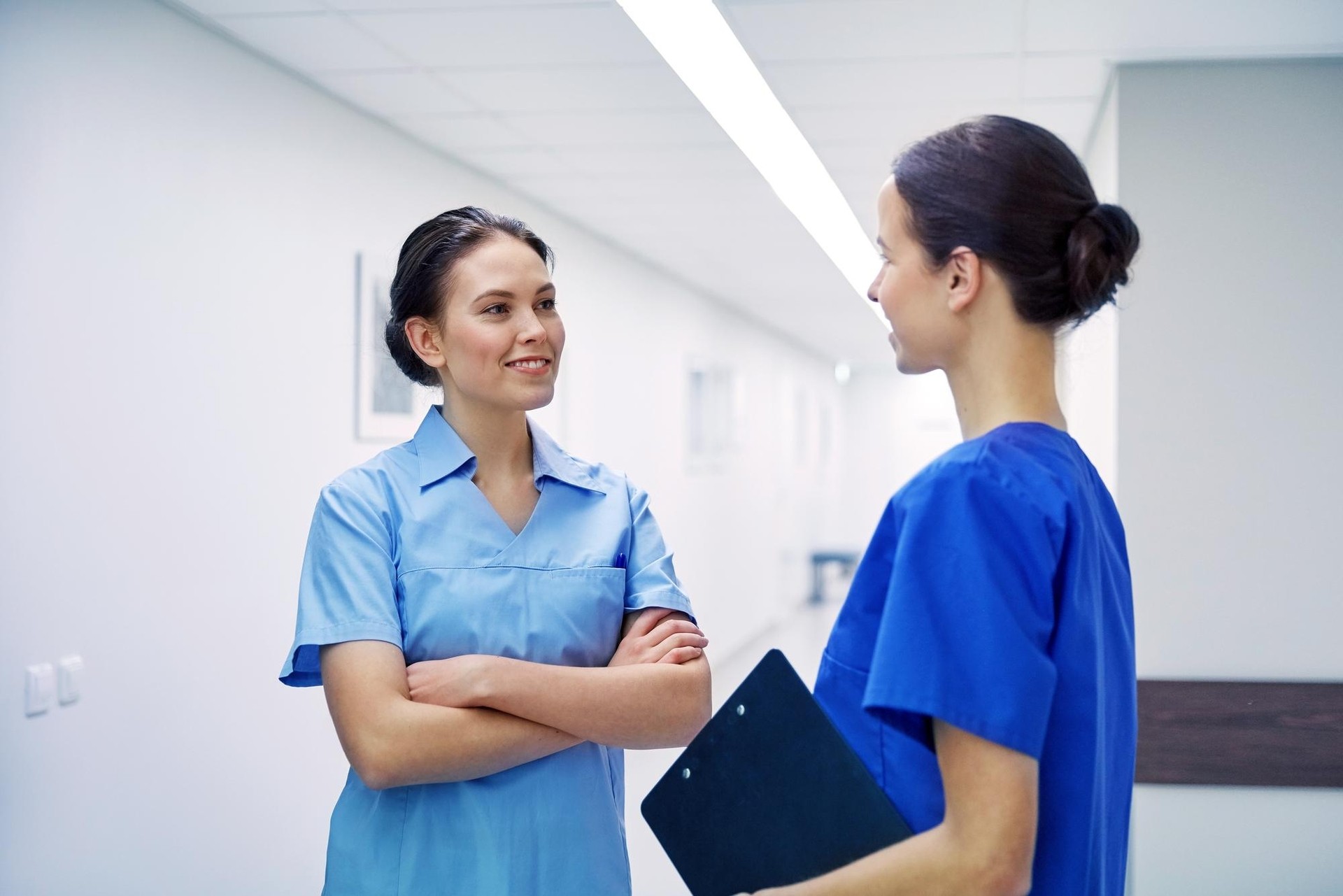 Two_female_nurses_engaged_in_conversation _ISM_Training_and_Recruitment