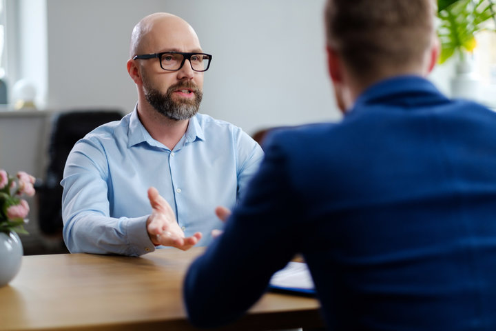 Two_men_are_seated_at_a_table _ISM_Training_and_Recruitment